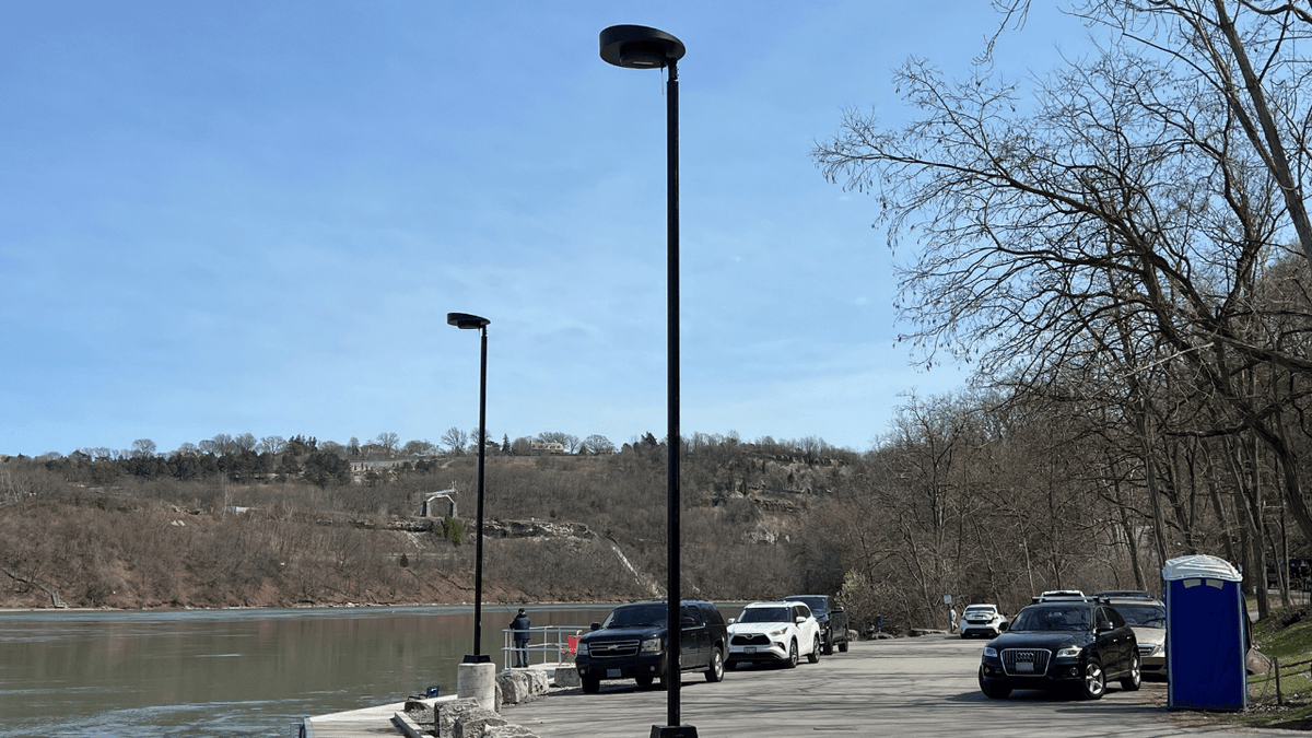 Senti solar all-in-one lighting a parking lot at night