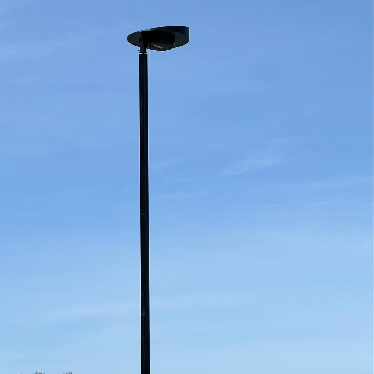 Senti solar all-in-one on an 18-foot pole against blue sky